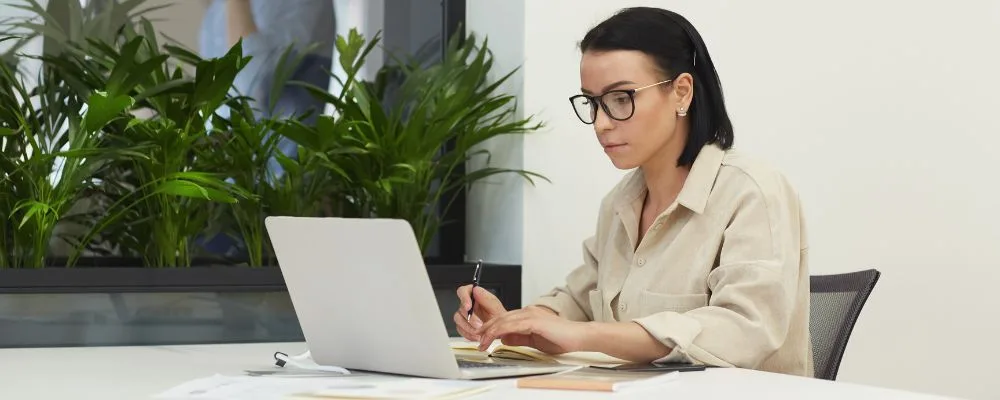 Woman sits at desk working on her SEO campaign