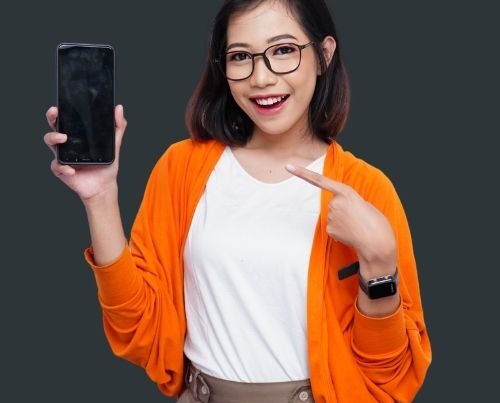 Content for Clicks woman holding mobile phone for social media.