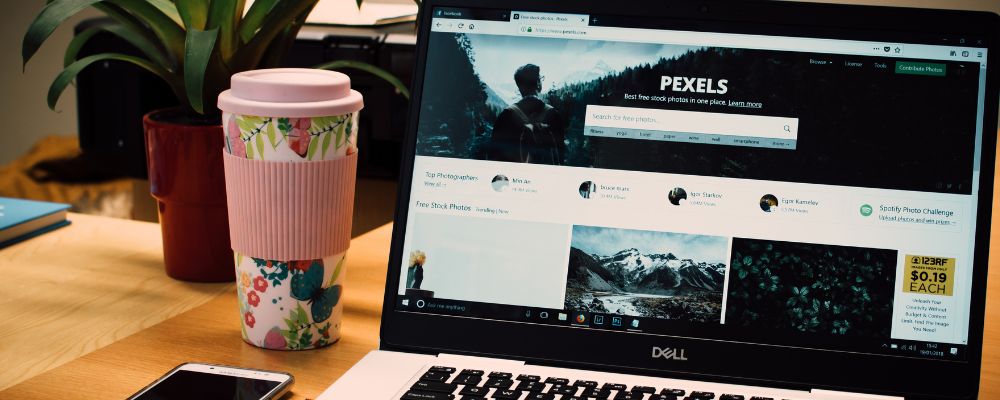 Open laptop shows a website with multiple images to be optimised.